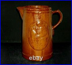 Early (1905 1925) Brown Girl with Dog Stoneware Pitcher